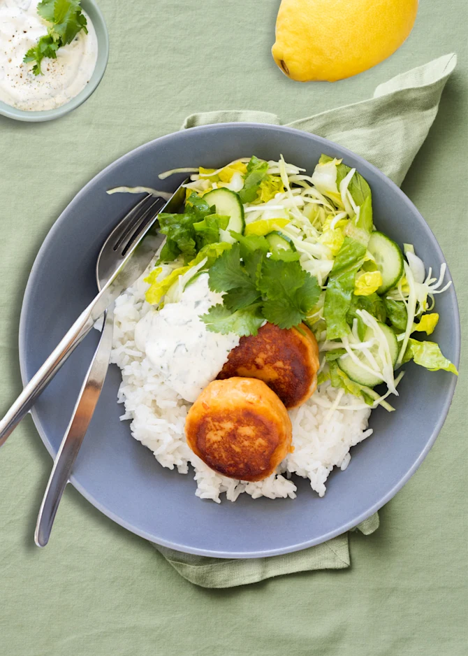 Krydrede fiskedeller med ris og sprød kålsalat. Hertil fraichedressing