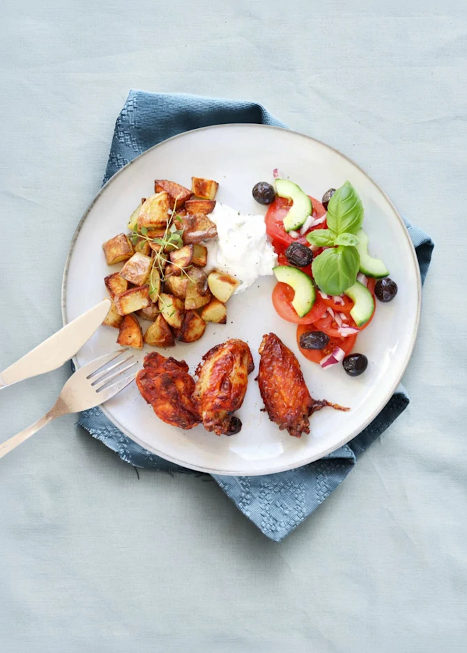 Smokey wings med timiankartofler og tomatsalat. Hertil tzatziki
