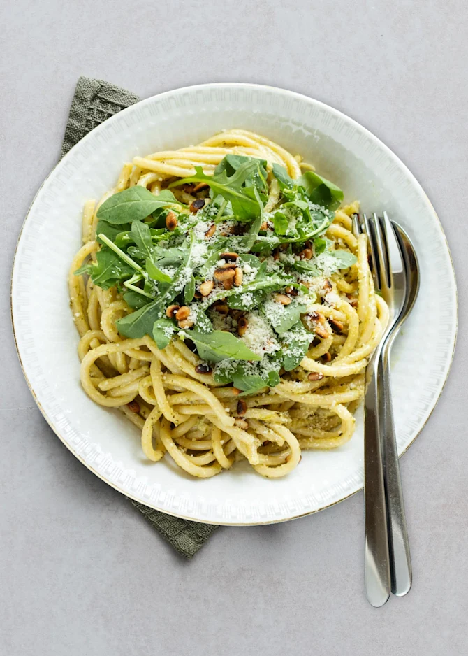 Pasta i cremet pestosauce med ristede pinjekerner og rucola